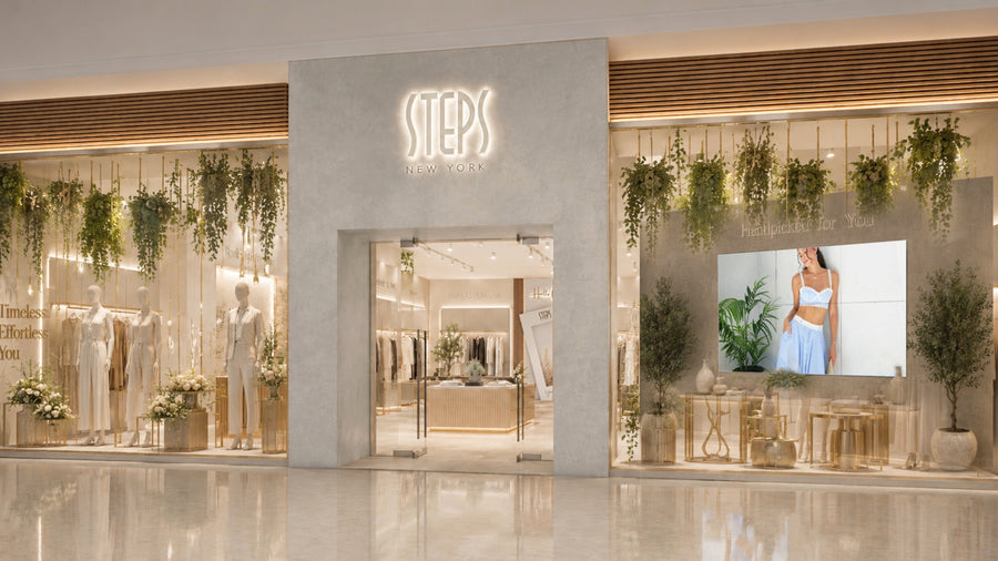 Steps New York storefront with window displays of neutral-toned outfits