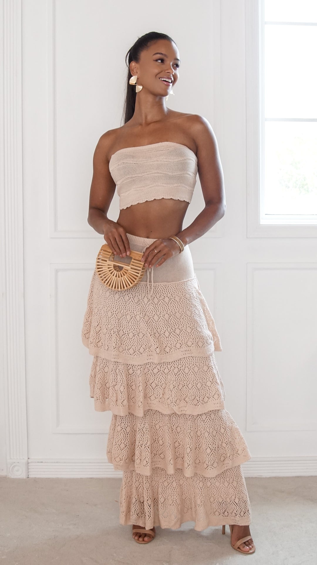 front view image 5 of Elara Skirt SetStyle: strapless crop top with lace-up back and tiered maxi skirt
Neckline: strapless
Fit: fitted top with flowy skirt
Color: beige
Occasion: vacation, beach outings, brunch, summer events